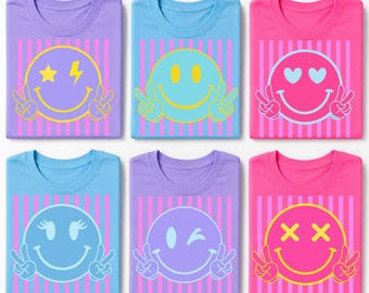 May include: Six t-shirts arranged in two rows, each featuring a vertical striped background and a large smiley face graphic. The shirts are purple, blue, and pink, with various smiley expressions including stars, hearts, and peace signs.