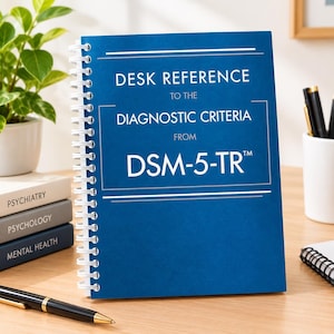 May include: A blue spiral-bound desk reference book titled Desk Reference to the Diagnostic Criteria from DSM-5-TR. The cover features white text and thin horizontal lines. It is positioned upright on a desk surface.