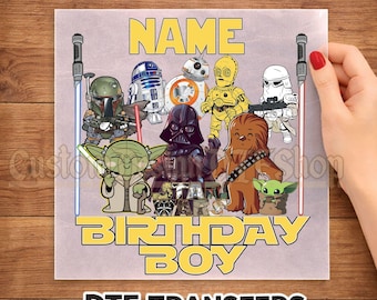 May include: A square DTF transfer sheet featuring cartoon Star Wars characters including Darth Vader, Yoda, Chewbacca, and droids. The text reads READY TO PRESS, NAME, and BIRTHDAY BOY. Two lightsabers frame the characters on the left and right sides.