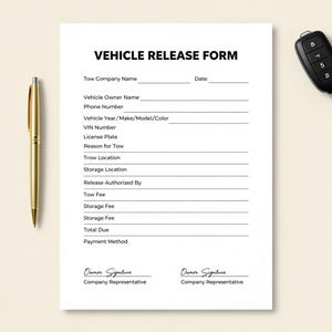 May include: A Vehicle Release Form printed on white paper with a gold pen and a car key fob. The form includes fields for tow company, vehicle owner, and vehicle details. The text "VEHICLE RELEASE FORM" is at the top.