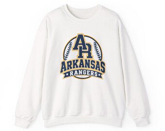 May include: A white long-sleeve crewneck sweatshirt featuring a graphic on the chest. The design includes the letters AR, the word ARKANSAS, and the word RANGERS in navy blue and gold, framed by a circular baseball stitch pattern and two stars.