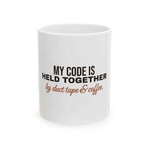 May include: A white ceramic mug featuring the black text MY CODE IS HELD TOGETHER and the brown cursive text by duct tape & coffee. The mug has a cylindrical shape with a smooth finish and is presented against a plain white background.