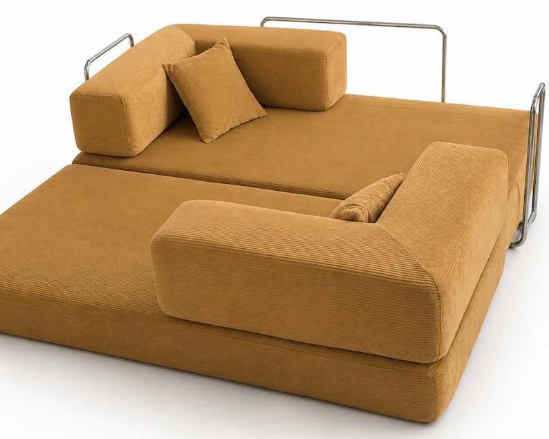 May include: A modular sofa bed upholstered in mustard yellow corduroy fabric. The piece features a low-profile design with two square cushions, two rectangular backrests, and a thin, silver-toned metal frame structure along the back and sides.