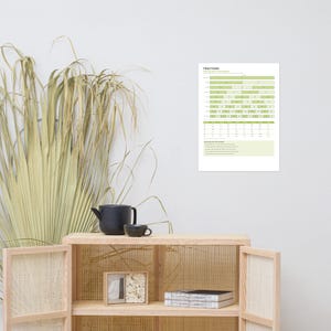 May include: A white educational poster titled FRACTIONS featuring a green and white chart with horizontal bars representing fractional parts, a conversion table, and a section titled THE RULES FOR THE WORK, all displayed on a plain wall.