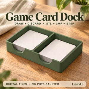 May include: A matte olive green rectangular game card dock featuring two separate compartments for card stacks. The text Game Card Dock, DRAW + DISCARD, STL + 3MF + STEP, and DIGITAL FILES - NO PHYSICAL ITEM, LizaraCo is printed on the image.