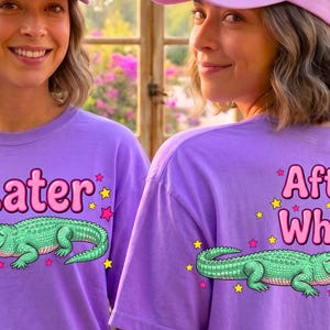May include: A lavender t-shirt featuring a green alligator graphic and the pink text Later on the front, and a green alligator graphic with the pink text After While on the back, accented by small yellow and pink stars surrounding the designs.