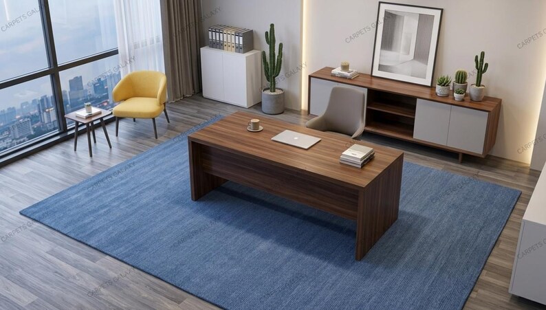 Solid blue hand-tufted wool rectangular area rug with medium Loop pile on wood flooring in a minimalist living room setting.