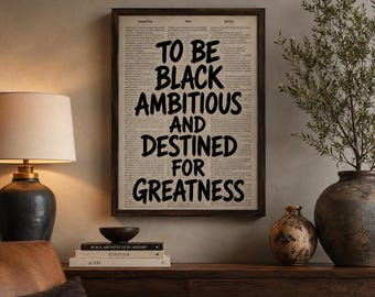 May include: A rectangular framed wall art piece featuring a vintage dictionary page background with the bold black text: TO BE BLACK AMBITIOUS AND DESTINED FOR GREATNESS. The print is encased in a dark brown wooden frame with a clean, simple border.
