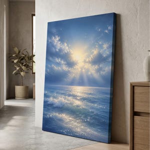 May include: A rectangular canvas print featuring a seascape with a bright sun shining through clouds above a blue ocean. The sun rays extend downward toward the water, creating a shimmering reflection on the surface of the waves and sea.