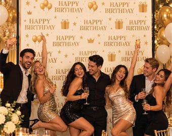May include: A white birthday backdrop featuring repeating gold text that reads Happy Birthday, interspersed with gold illustrations of gift boxes, balloons, stars, and crowns. The banner is mounted on a black metal frame stand.
