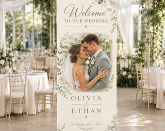 May include: A vertical wedding welcome banner featuring a cream background with floral accents, a central photograph of a couple, and the text Welcome TO OUR WEDDING, OLIVIA & ETHAN, and So happy you're here, displayed in elegant typography.