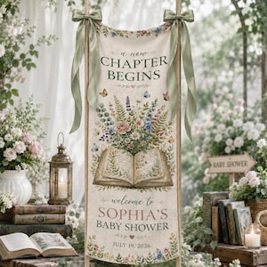 May include: A vertical fabric banner featuring the text A NEW CHAPTER BEGINS, an illustration of an open book with a floral bouquet, and the text welcome to SOPHIA'S BABY SHOWER JULY 19, 2026. The banner is tied with sage green ribbons at the top.