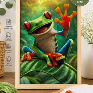 May include: A cross stitch pattern digital download featuring a vibrant red-eyed tree frog with green skin, blue legs, and orange feet sitting on a leaf. The image includes text: CROSS STITCH PATTERN, Digital Download, 163 x 250 STITCHES, 120 COLORS DMC.