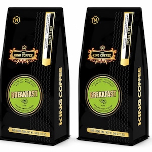 May include: Two black bags of TNI King Coffee Breakfast Blend whole bean coffee. Each bag features a green circular label with the text Breakfast Blend and Bittersweet Citrus Notes. The packaging displays a net weight of 340 grams or 12 ounces.