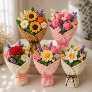 May include: Five distinct crochet flower bouquets arranged together. Each bouquet features a variety of handcrafted yarn flowers including sunflowers, tulips, roses, and daisies, wrapped in textured crochet paper tied with a small bow.