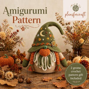 May include: A crochet gnome doll featuring a tall olive green hat decorated with an embroidered gold crescent moon, stars, and leaves. The gnome has a round orange pumpkin nose, a long cream-colored beard, and braided orange side hair.
