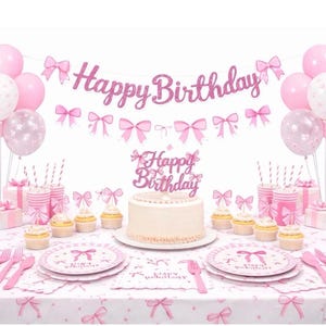 May include: A birthday party set featuring a pink glittery Happy Birthday banner with bows, a matching cake topper, pink and white balloons, plates, cups, and napkins decorated with bow patterns, and a frosted cake on a white tablecloth.