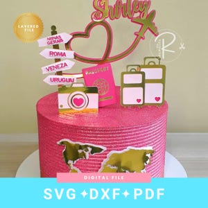May include: A pink glittery cake topper set featuring a gold name Shirley, a heart, an aeroplane, a camera, a passport, two suitcases, and a signpost with locations Minas Gerais, Roma, Veneza, and Uruguai, plus a gold world map cutout.