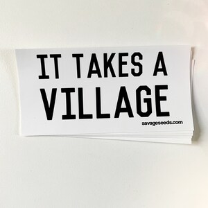 May include: White sticker with black text that reads "IT TAKES A VILLAGE" and the website "savageseeds.com" in the bottom right corner.