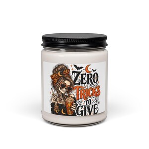 May include: A white candle in a glass jar with a black lid. The label features a skeleton with a messy bun, leopard print bow, and heart-shaped sunglasses, holding a pumpkin-themed drink. Text reads: ZERO TRICKS TO GIVE.