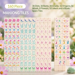 May include: A 160-piece Mahjong tile set. The tiles are white with colorful illustrations and characters. The set includes dots, bams, cracks, dragons, winds, flowers, jokers, and spare tiles. The text "MAHJONG TILES" is at the top.