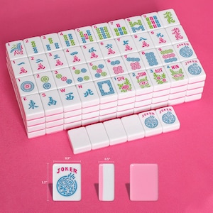 May include: A set of white mahjong tiles with colorful engraved characters, numbers, and symbols. The tiles feature red, blue, and green designs. A single tile is shown with dimensions of 1.2 inches by 0.9 inches by 0.5 inches next to a ruler.