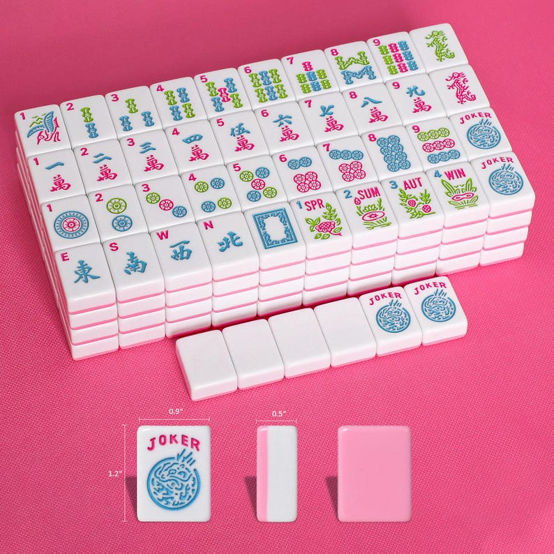 May include: A set of white mahjong tiles with colorful engraved characters, numbers, and symbols. The tiles feature red, blue, and green designs. A single tile is shown with dimensions of 1.2 inches by 0.9 inches by 0.5 inches next to a ruler.