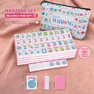 May include: A Mahjong set with white tiles featuring colorful symbols and characters, including a "Joker" tile. The set includes a stylish bag with a floral and character design. The set is designed for family and friends.