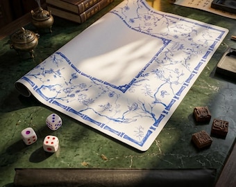 May include: A large rectangular paper mat featuring a blue and white botanical print with bamboo-style borders. The mat is accompanied by three white dice with colored pips and two small square wooden blocks with carved symbols on their surfaces.