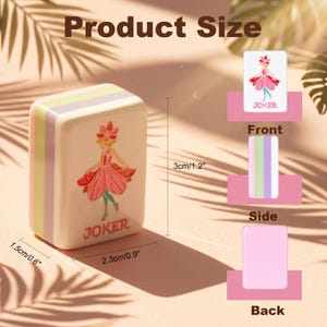 May include: A decorative Joker tile, measuring 2.3 inches long, 1.5 inches wide, and 3 inches tall. The tile features a pink and red illustration of a woman in a dress, with the word "JOKER" below. The side has pastel stripes.