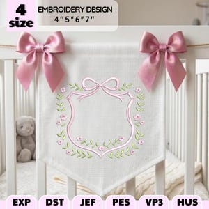 May include: A white fabric banner featuring an embroidered pink ribbon frame surrounded by green leaves and small pink flowers. The banner is adorned with two pink satin bows at the top corners. Text reads: 4 size EMBROIDERY DESIGN 4" 5" 6" 7".