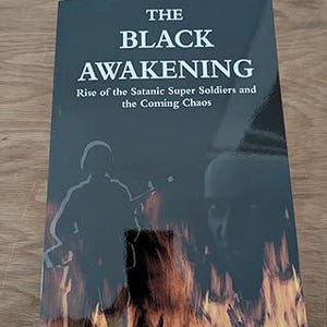 May include: A book titled "The Black Awakening" with the subtitle "Rise of the Satanic Super Soldiers and the Coming Chaos." The cover features a dark background with silhouettes of soldiers and flames.