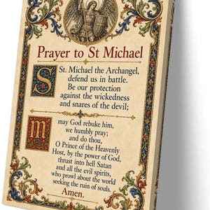 May include: A rectangular wall art print featuring the Prayer to St Michael. The text is centred on a parchment-coloured background with an ornate, colourful floral border. At the top, an illustration of St Michael the Archangel is depicted.