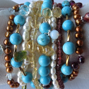 Multi strand turquoise, pearl,semi preciouse stones and sterling silver bracelet.Aquamarine, garnets,citrine,fresh water pearls.