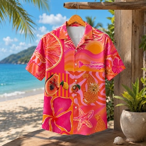 May include: A short-sleeve button-down shirt featuring a vibrant, multi-colored tropical print. The design includes pink hibiscus flowers, orange citrus slices, a starfish, a leopard, and wavy patterns in shades of pink, orange, and yellow.