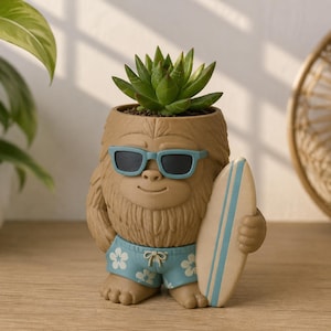May include: A tan, furry creature-shaped planter holding a green succulent. The figure wears light blue sunglasses and matching swim trunks with a white floral pattern. It holds a light-colored surfboard with blue stripes under one arm.