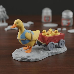 May include: A yellow duck figurine pulling a red wagon filled with five yellow ducklings. The duck wears a blue vest and is attached to the wagon with a rope. The figurine is on a gray stone base.
