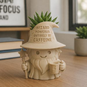 May include: A beige, 3D-printed wizard-shaped planter featuring a pointed hat with the text WIZARD POWERED ENTIRELY BY CAFFEINE. The figure has a beard, holds a star-topped wand in one hand and a mug with a lightning bolt icon in the other.