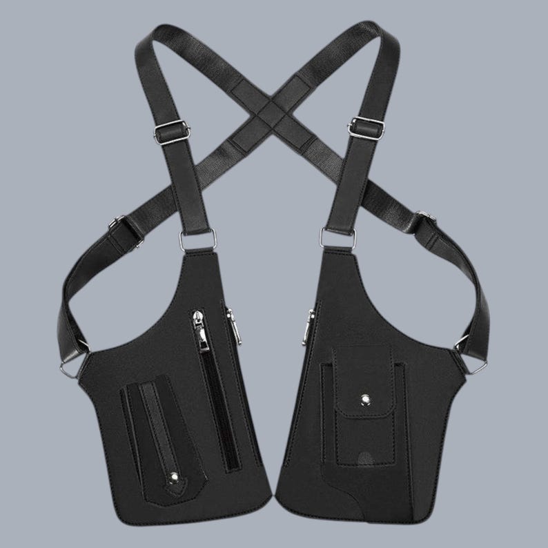 Premium black leather shoulder holster bag and techwear chest rig with an adjustable X-strap design. Includes a vertical zipper pocket and a utility pouch with a silver snap button, shown isolated on a solid gray background.