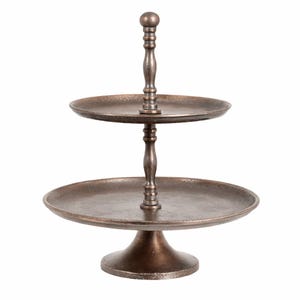 May include: A two-tiered serving stand with a dark bronze, textured finish. The stand features a wide circular base, a larger bottom tray, and a smaller top tray connected by a central spindle with a spherical finial at the very top.