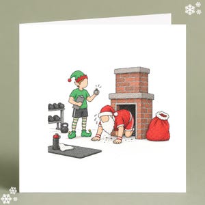 May include: A square greeting card featuring a colored illustration of Santa Claus in athletic gear crawling out of a brick fireplace, while an elf in a green shirt and striped leggings holds a clipboard and a small bottle in a gym setting.