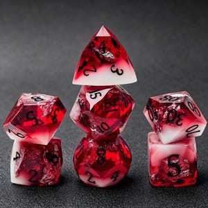 May include: A set of polyhedral dice featuring a gradient of translucent deep red and opaque white resin with embedded silver foil flakes. Each die has clear black numerals printed on the surfaces, arranged in three small stacks.