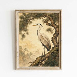 May include: Framed art print featuring a crane perched on a tree branch. The artwork has a vintage aesthetic with a muted color palette of beige, brown, and green. The crane is depicted in detail, with a long beak and elegant posture. The background suggests a landscape.
