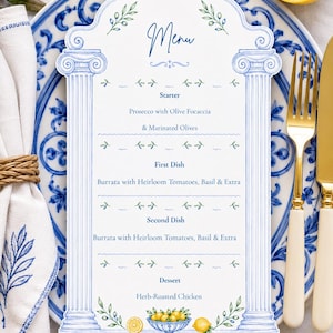 May include: A die-cut menu card featuring blue architectural columns and green olive branch illustrations. The text reads Menu, Starter, Prosecco with Olive Focaccia & Marinated Olives, First Dish, Burrata with Heirloom Tomatoes, Basil & Extra, Second Dish, Burrata with Heirloom Tomatoes, Basil & Extra, Dessert, Herb-Roasted Chicken.