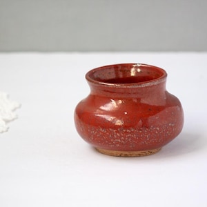 May include: A set of three ceramic mugs with a speckled, matte finish. The mugs are in shades of cream, light gray, and dark gray. Each mug has a simple, minimalist design, perfect for coffee or tea.