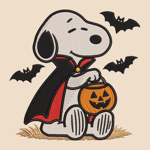 May include: An embroidered design of a white dog character wearing a black cape with a red lining, holding an orange jack-o'-lantern pumpkin bucket. Three black bats are flying around the character, which sits on a patch of tan grass.