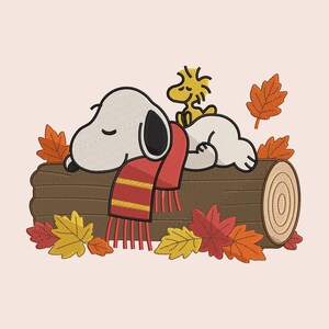 May include: An embroidered design featuring a white beagle and a small yellow bird sleeping on a brown log. The beagle wears a red scarf with yellow stripes. The scene is surrounded by colorful autumn leaves in shades of red, orange, and yellow.