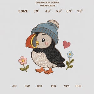 May include: Machine embroidery design featuring a puffin wearing a blue knit hat, accompanied by a pink heart and two small flowers. Text includes EMBROIDERY DESIGN FOR MACHINE and sizes 3.9", 4.9", 5.9", 6.9", 7.9". File formats listed are JEF, EXP, DST, PES, VP3, HUS.