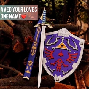 May include: A blue and silver sword with a blue-wrapped hilt, a matching blue scabbard with gold detailing, and a blue shield featuring a red bird emblem and a yellow triangle. The text ENGRAVED YOUR LOVES ONE NAME is visible in the upper left corner.