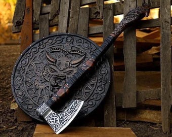 May include: A dark brown wooden axe with a carved wolf head on the handle and a silver blade featuring intricate knotwork patterns and the text "SCORCHED WOLF MENTALITY PREVAILS," resting against a circular black shield with a wolf face carving.